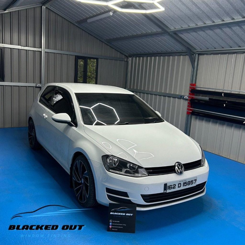White Golf in a window tinting garage